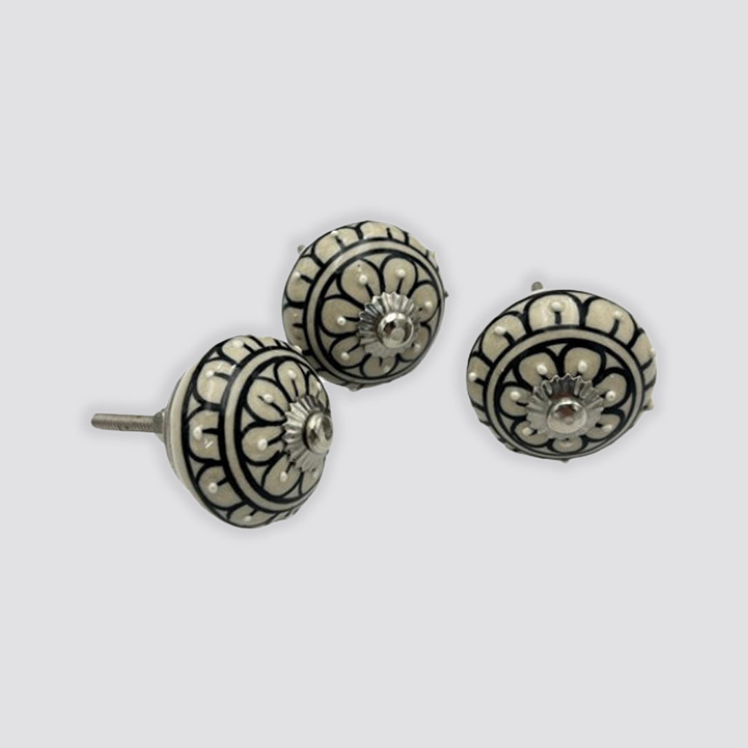 Ceramic cream doorknob with black leaf flower